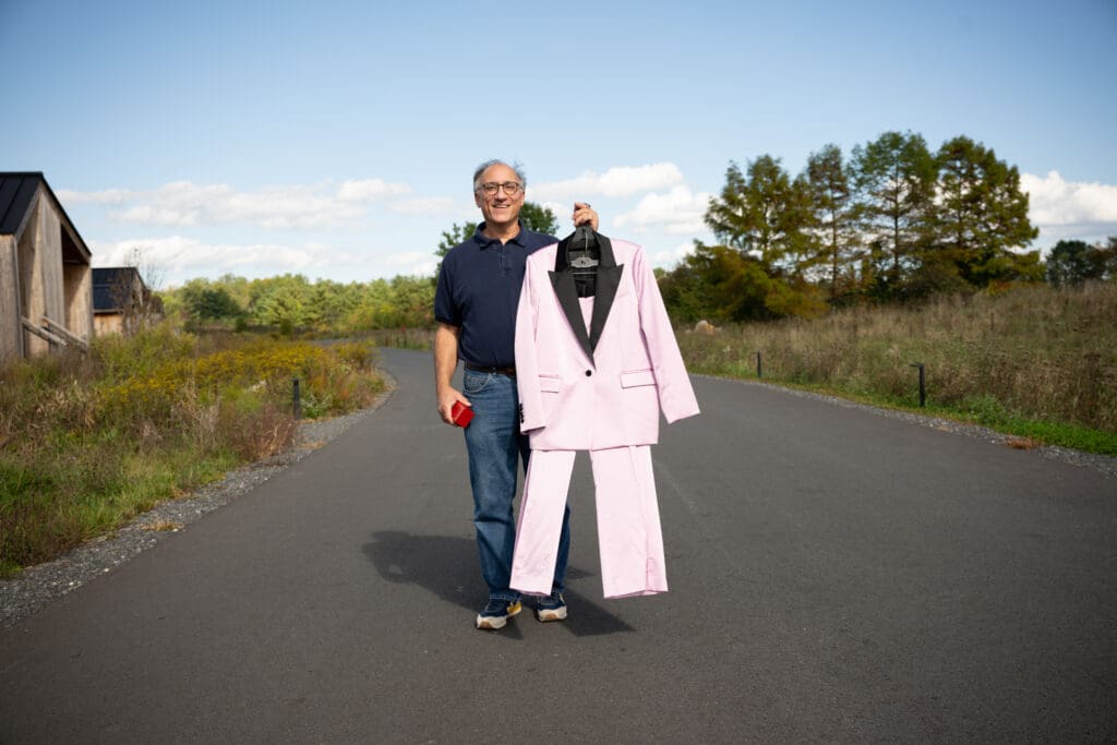 a bride's dad holds her suit and ring box at Wild Flower Farms in Gardiner NY