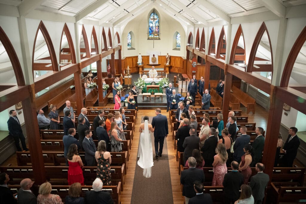 bride walks down aisle at St John Darien